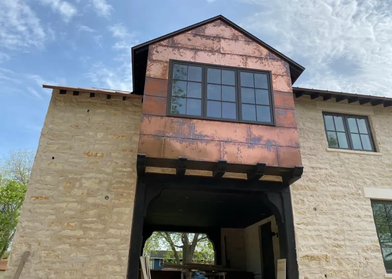 Copper metal panel facade on a stone building for Roof Repair in Prunedale